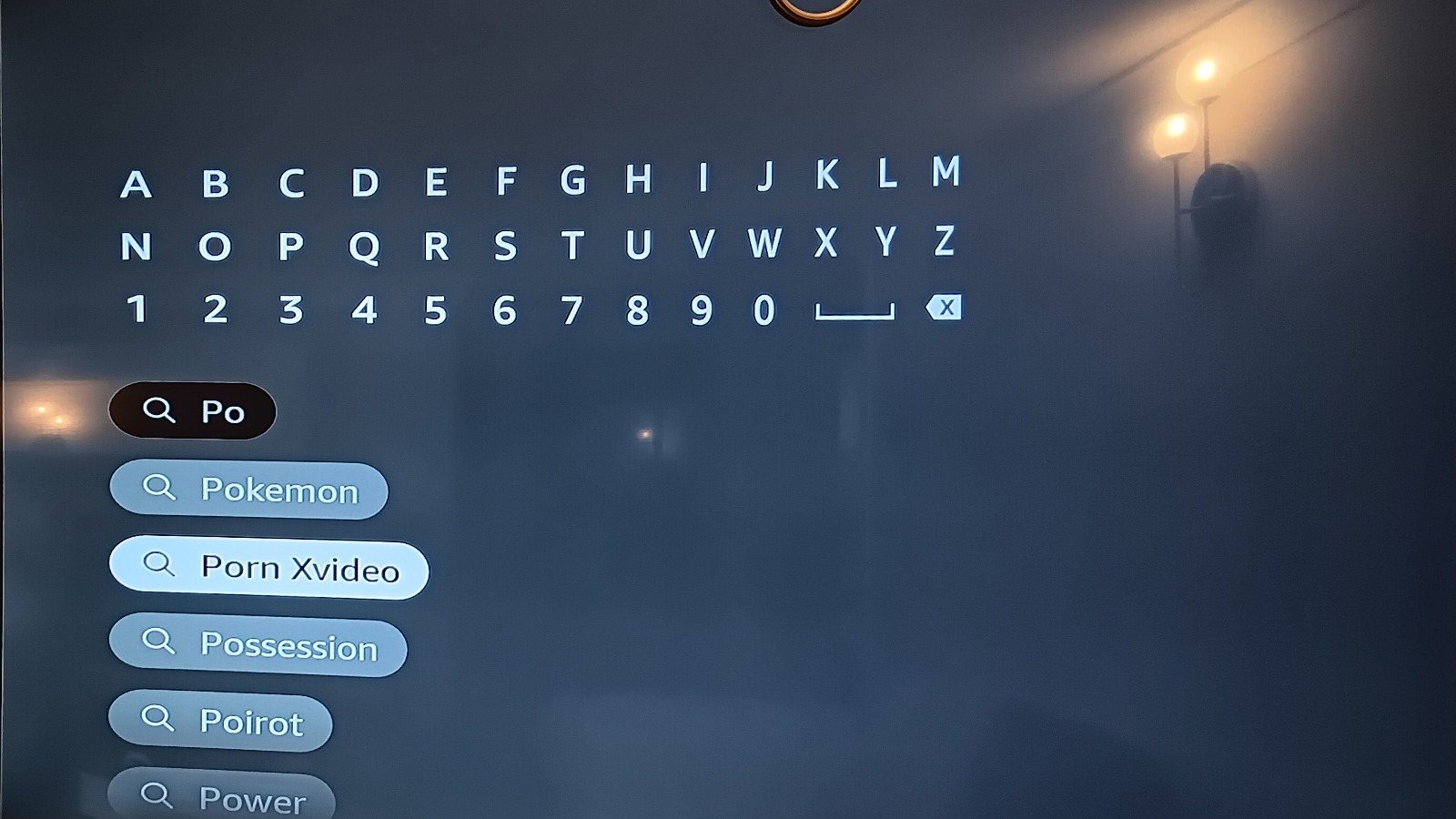The Fire TV search screen. Under the typed letters "Po", the suggestion list reads: Pokemon, Porn Xvideo, Possession, Poirot, Power.